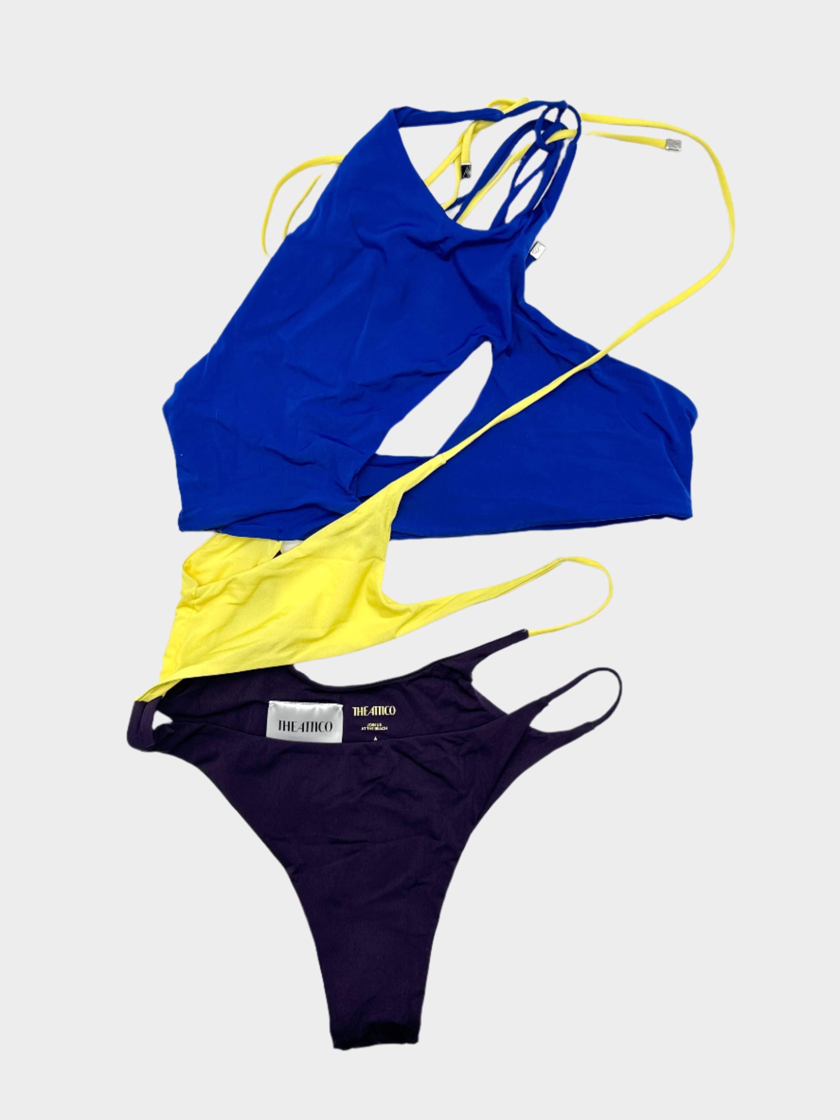 Scopri il costume intero cut-out di The Attico. Design audace e colori vibranti per un look esclusivo e di tendenza.