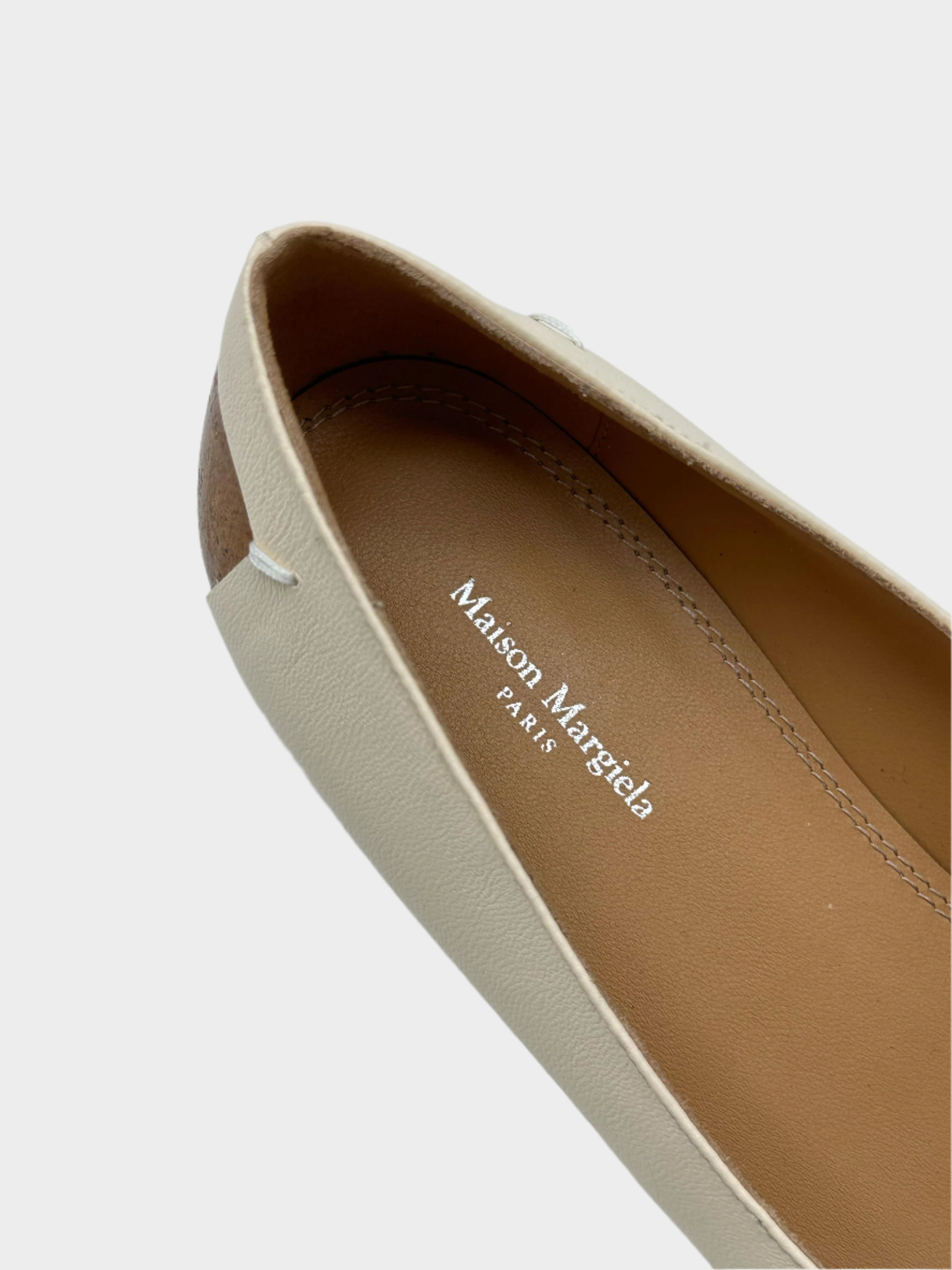 Cream-colored shoe with iconic heel detail