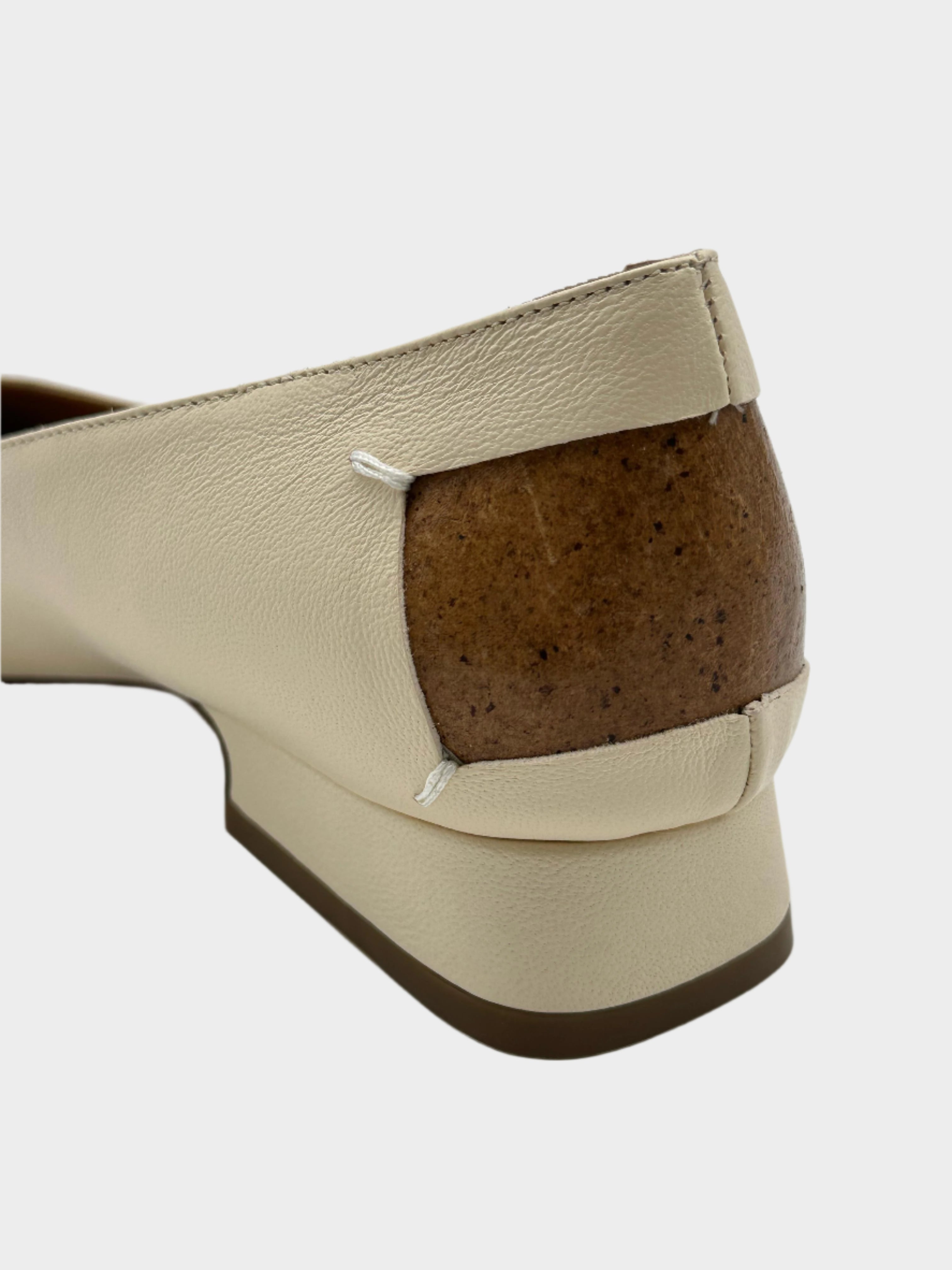 Cream-colored shoe with iconic heel detail