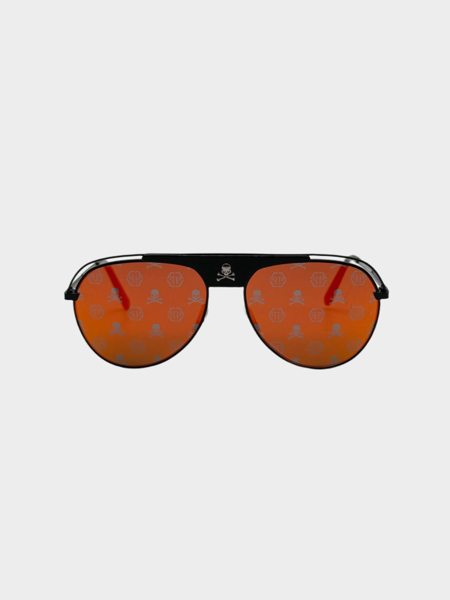Vista frontale degli occhiali Philipp Plein con lenti arancioni e monogramma inciso