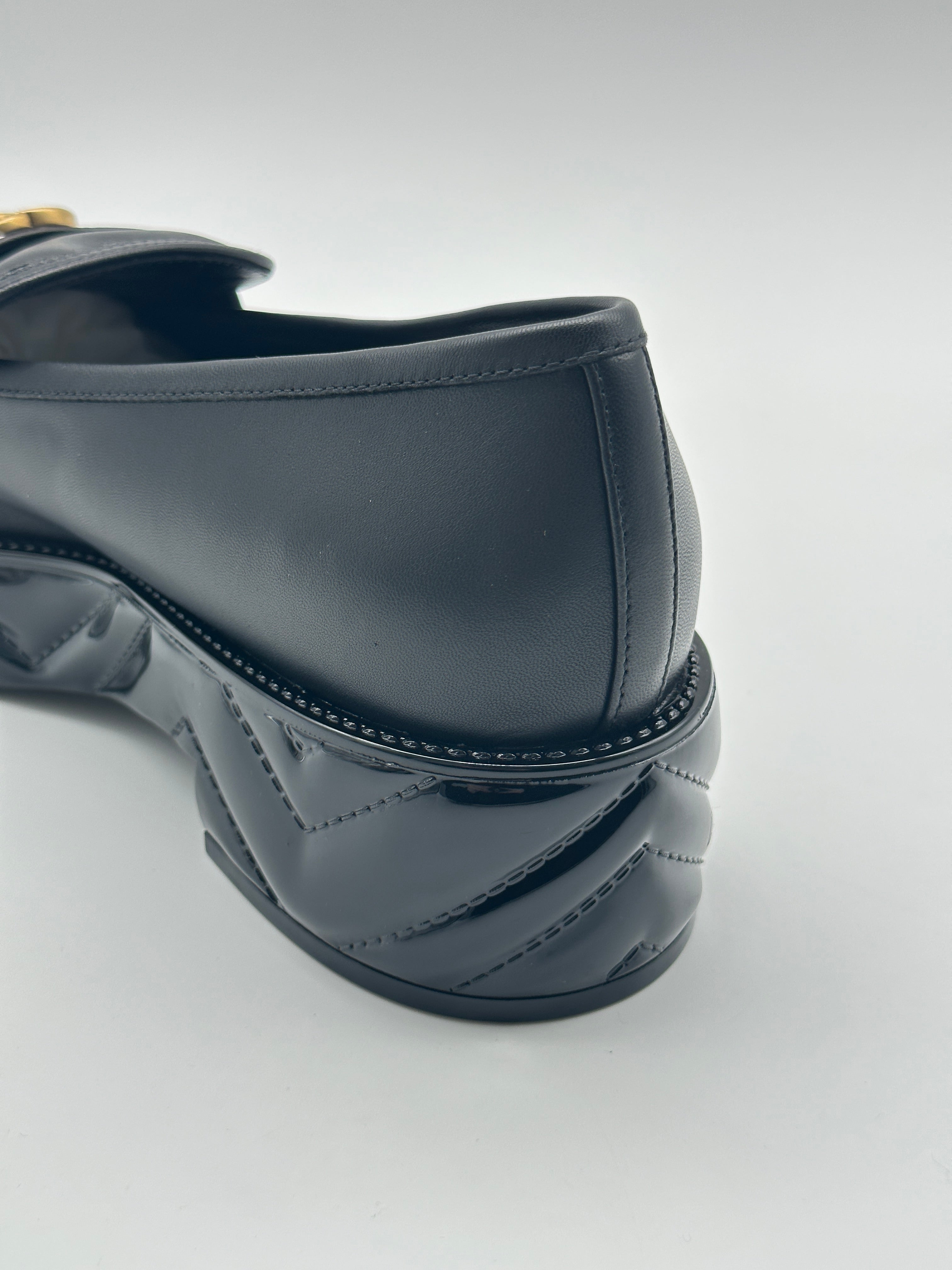Platform Loafers con punta arrotondata, logo dorato, suola matellassé e piattaforma da 5 cm. Eleganza e comfort.