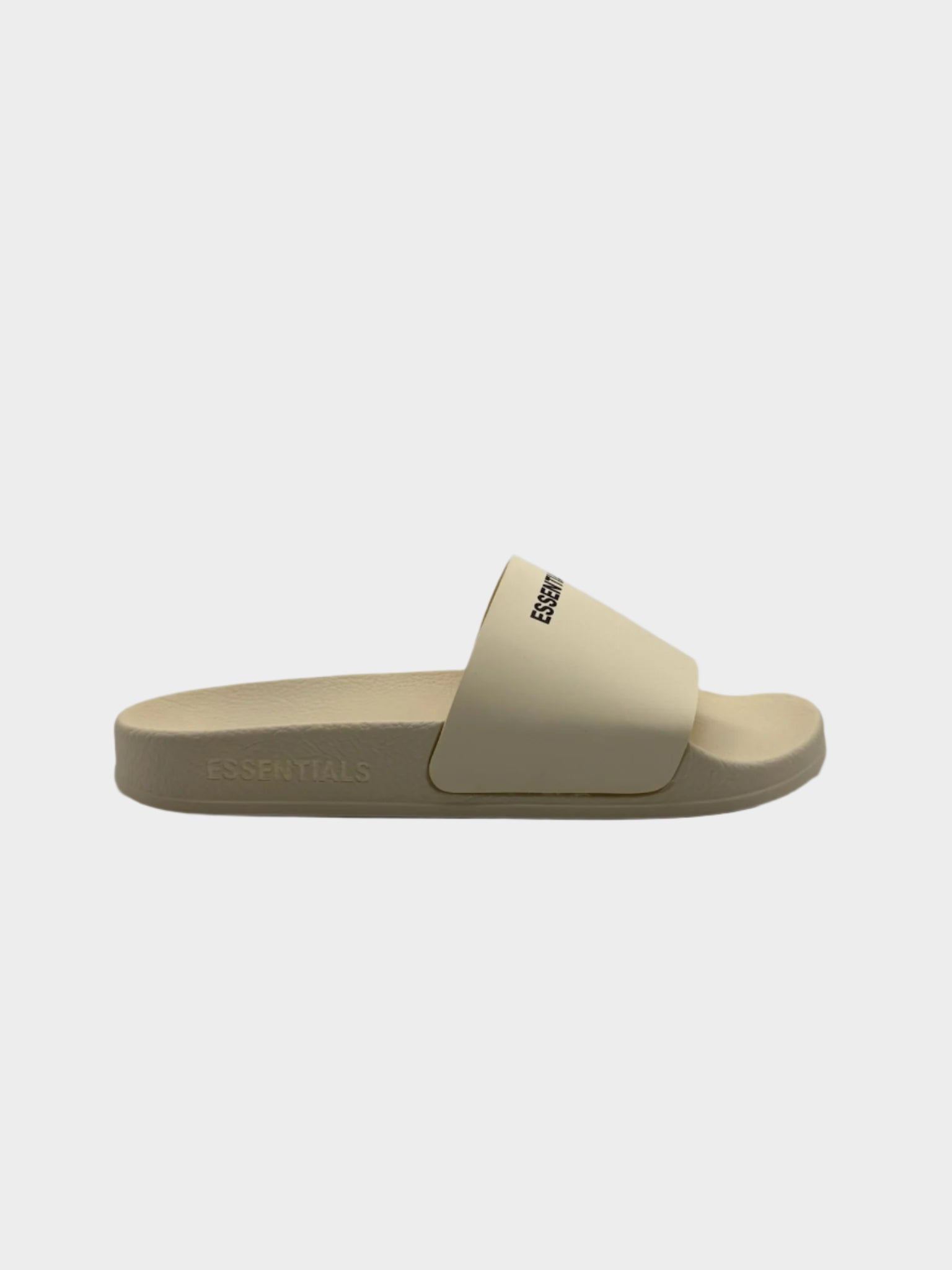 Vista laterale delle ciabatte Fear Of God Essentials in colore cream