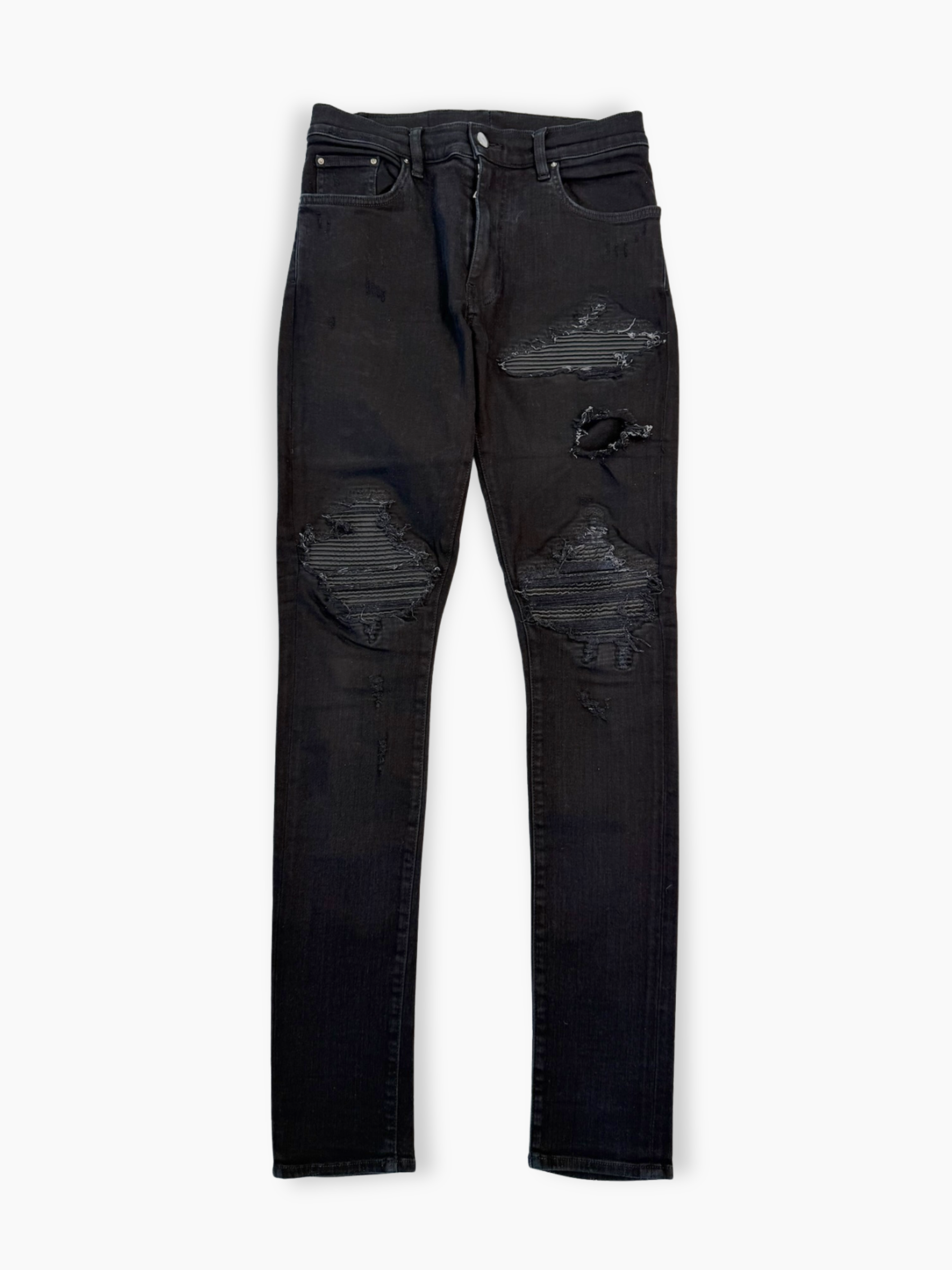 Jeans neri skinny Amiri con strappi e patch tono su tono