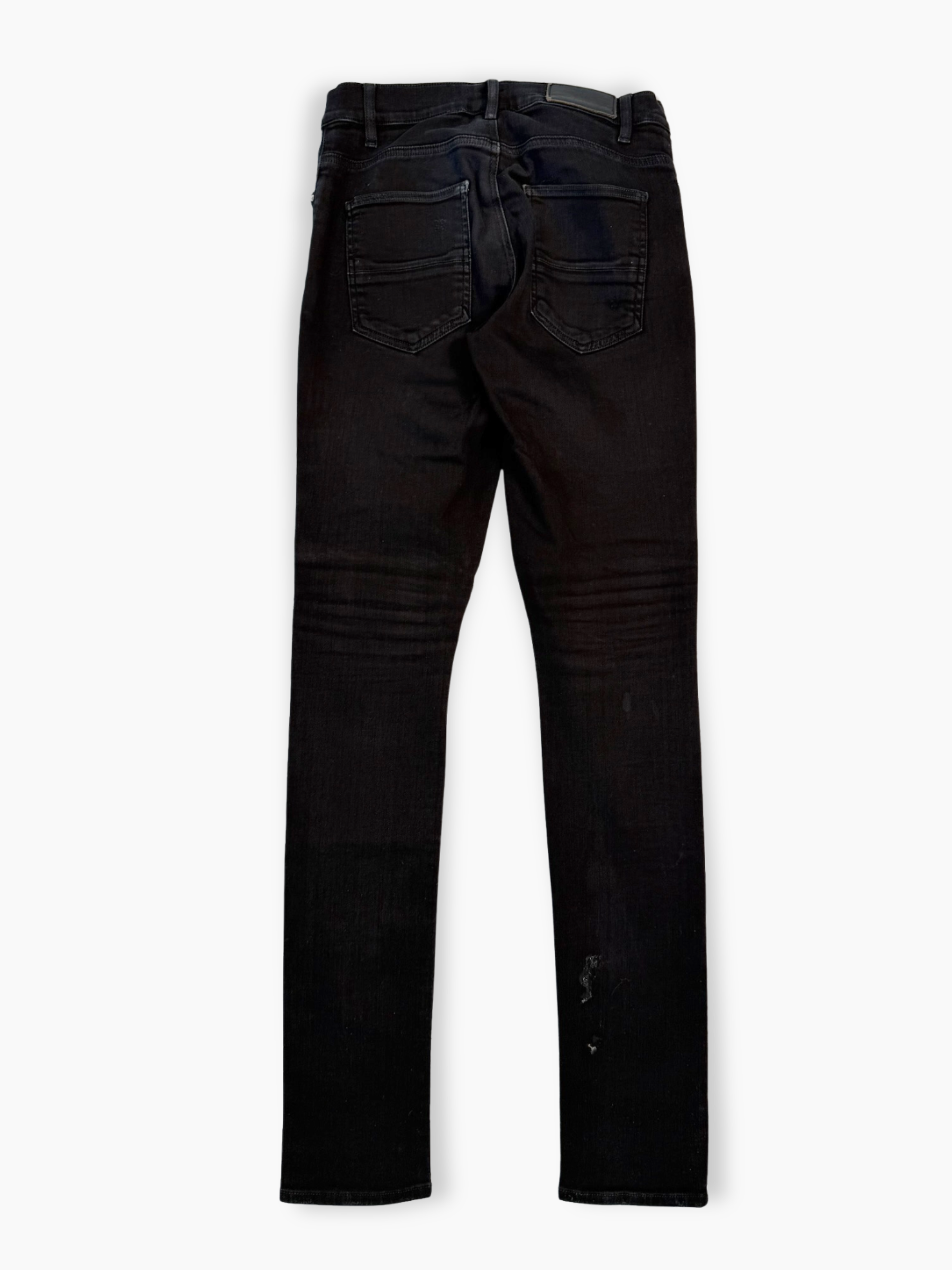 Jeans neri skinny Amiri con strappi e patch tono su tono