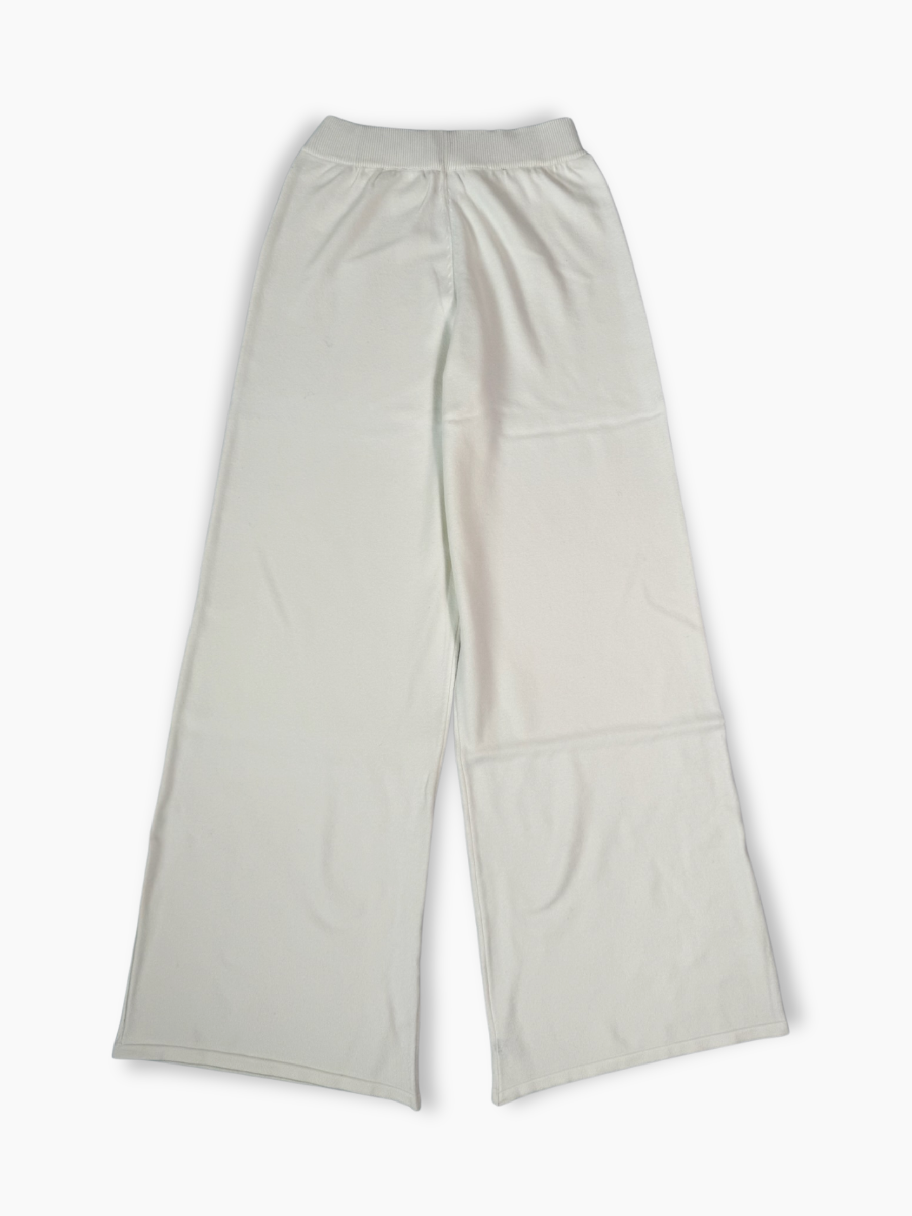 Pantaloni a palazzo in maglia bianchi con logo tono su tono ricamato sulla gamba