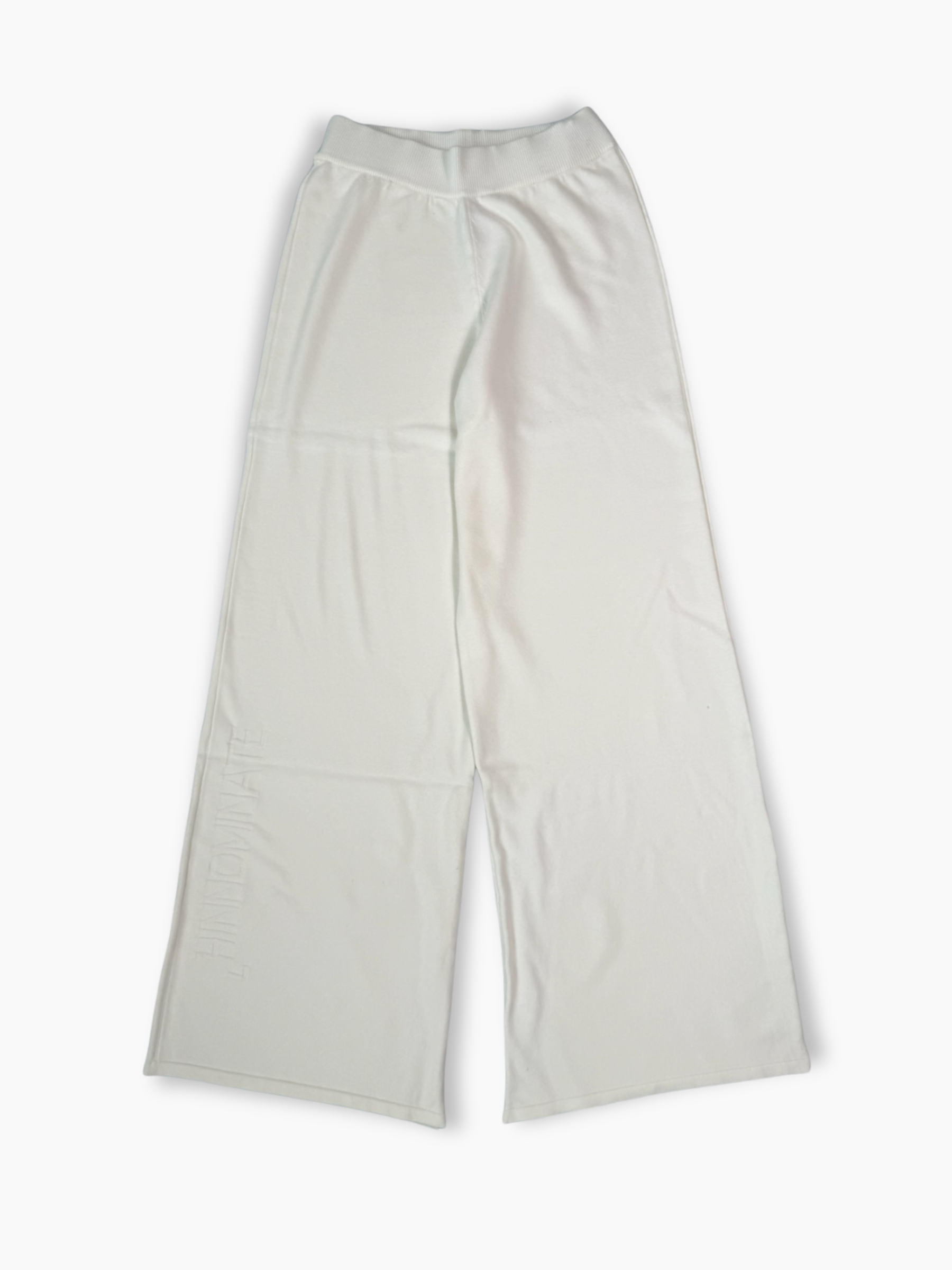 Pantaloni a palazzo in maglia bianchi con logo tono su tono ricamato sulla gamba