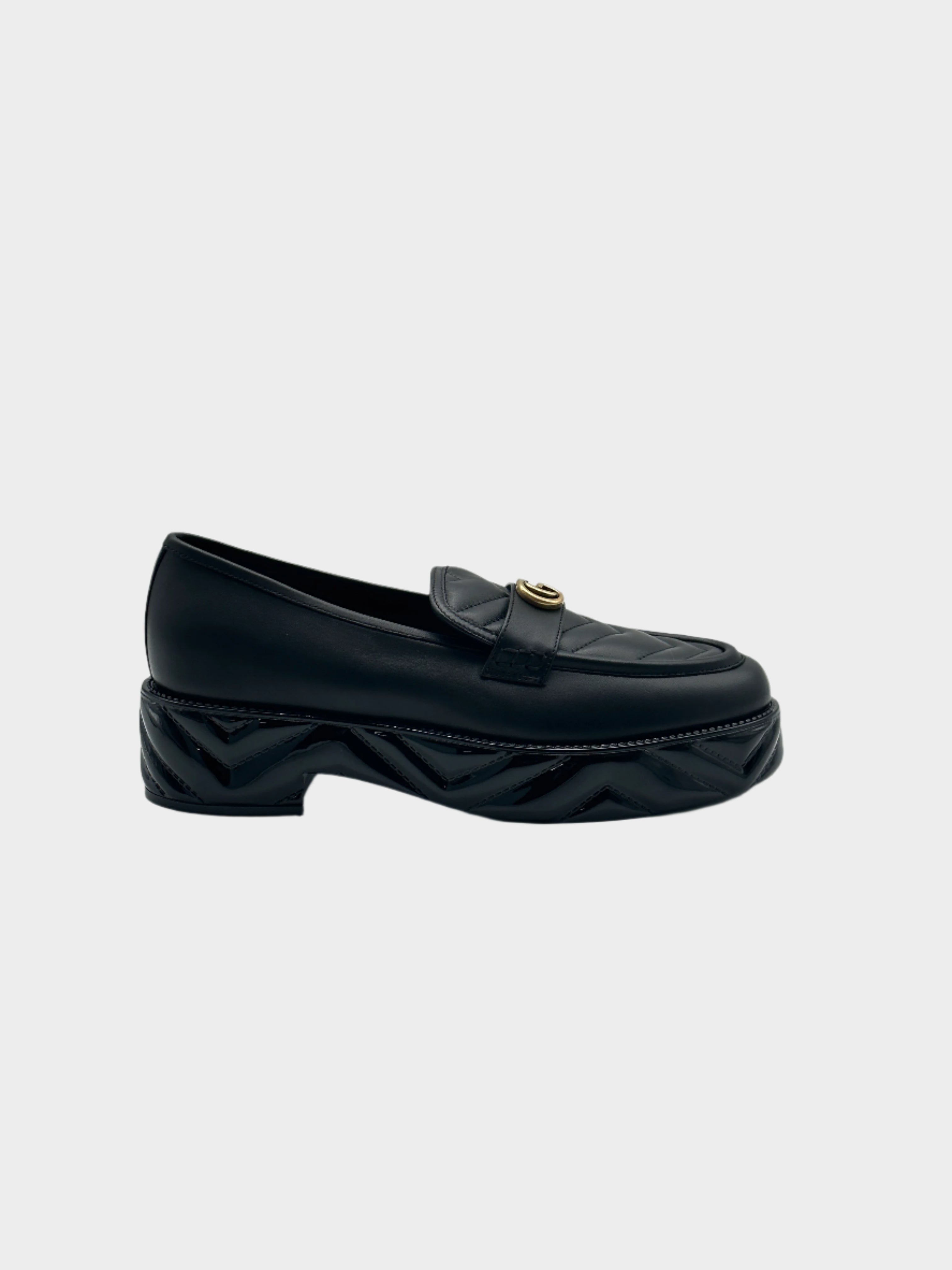 Platform Loafers con punta arrotondata, logo dorato, suola matellassé e piattaforma da 5 cm. Eleganza e comfort.